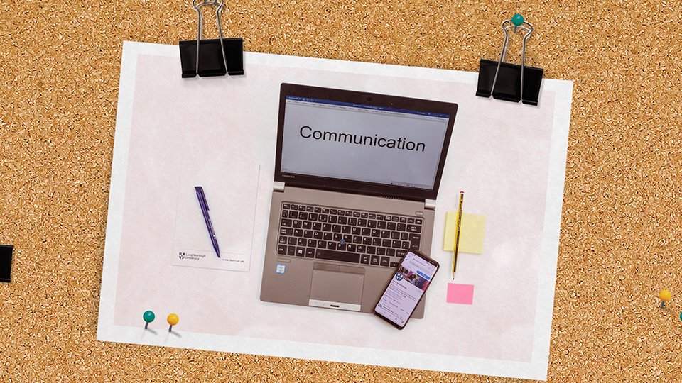A laptop with the word communication on the screen, surrounded by equipment